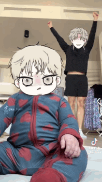 a baby in a blue and red outfit is sitting in front of a man in a black sweater