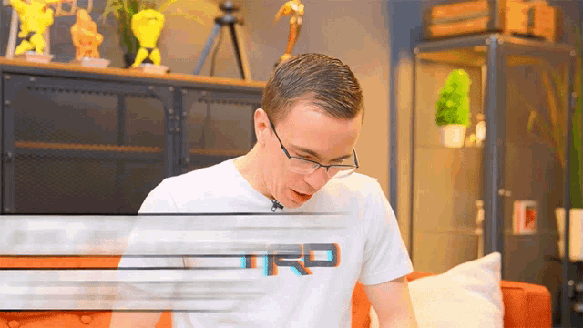 a man wearing glasses and a trd t-shirt