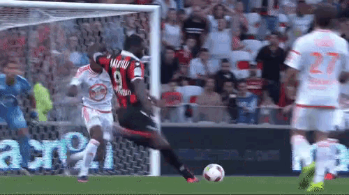a soccer player with the number 9 on his jersey is kicking a soccer ball .