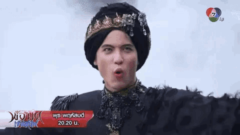 a man with a crown on his head is making a face .