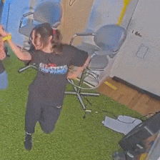 a man and a woman are dancing in a room and the woman is wearing a shirt that says all star on it