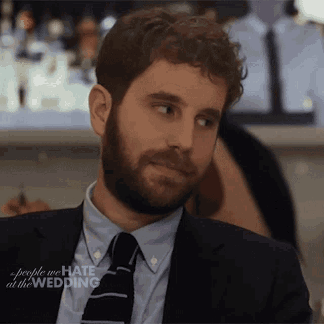 a man in a suit and tie with the words people we hate at the wedding written on the bottom