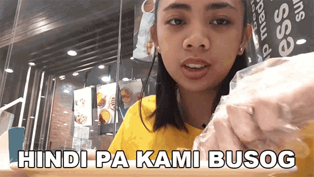 a woman holding a bag of food with the words hindi pa kami busog on the bottom