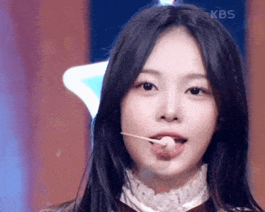 a close up of a woman 's face with the kbs logo in the corner