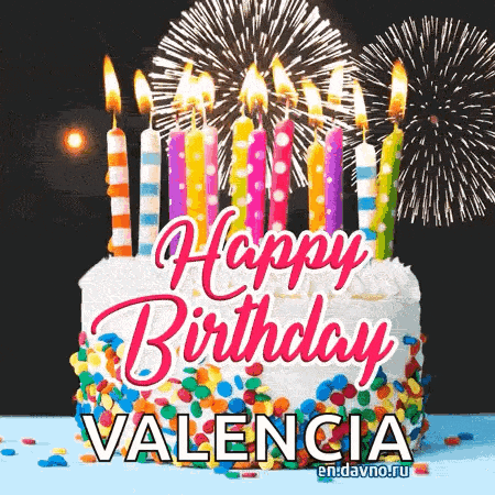 a birthday cake with candles and fireworks and the name valencia on it