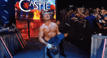 a man in a wrestling ring with a castle sign behind him
