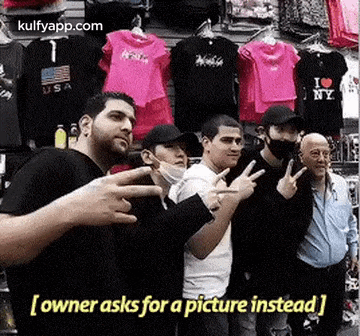 a group of men are standing next to each other in front of a store .