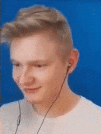 a young man wearing headphones is smiling and looking at the camera .