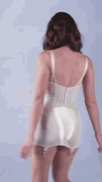 the back of a woman wearing a white corset and garters