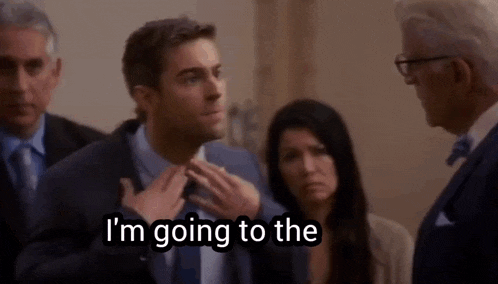 a man in a suit says i 'm going to the while adjusting his tie .