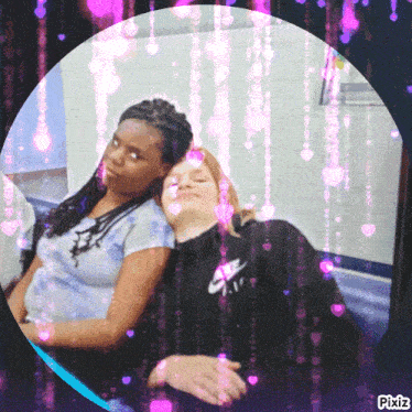 a girl wearing a nike sweatshirt is hugging another girl on a train
