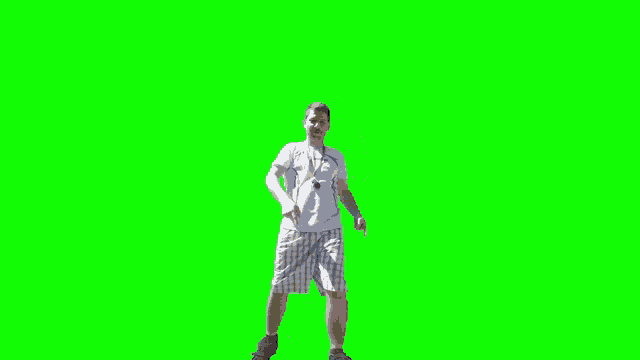 a man in shorts is dancing on a green screen .