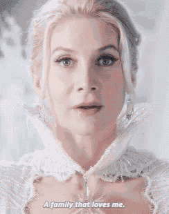 a woman in a white dress is talking about a family that loves me .