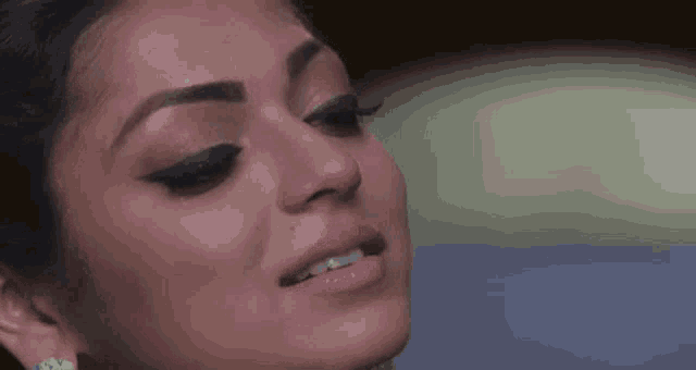 a close up of a woman 's face with tears running down her face .