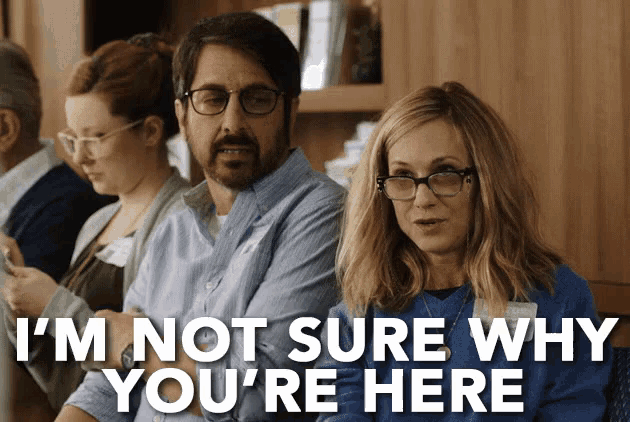 a group of people are sitting in a room and one of them says i 'm not sure why