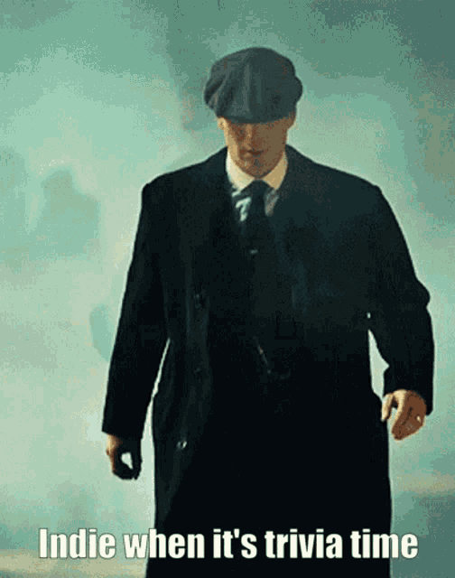 a man in a suit and hat walking with the words indie when it 's trivia time