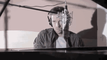 a man wearing headphones is sitting in front of a microphone
