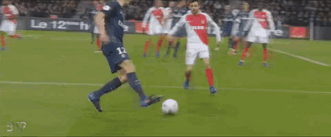 a soccer player with the number 12 on his jersey is running on the field