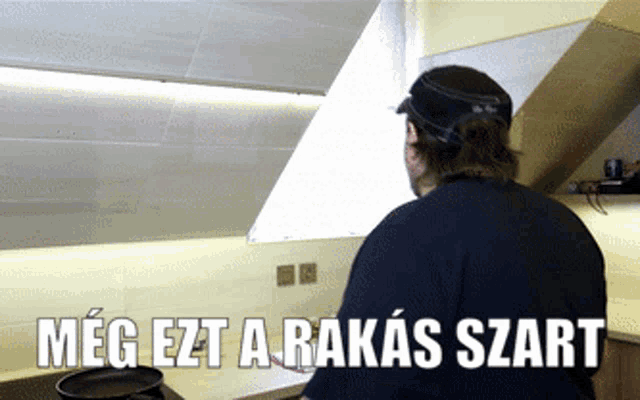 a man cooking in a kitchen with the words meg ezt a rakás szart written on the bottom