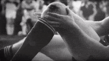 a black and white photo of a person holding a knee