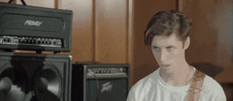 a young man is playing a guitar in front of an amplifier that says peavey