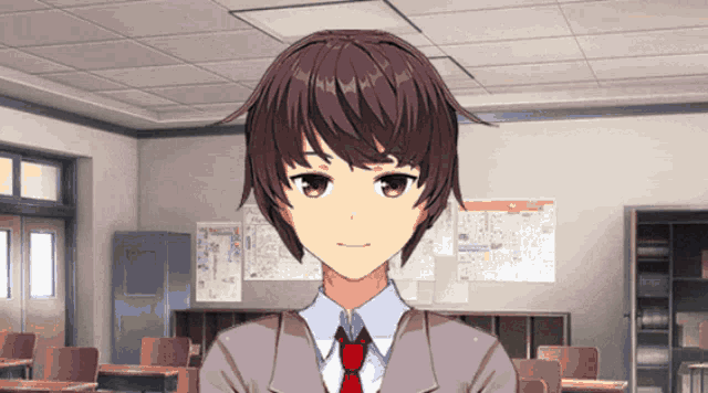 a boy in a suit and tie stands in front of a classroom