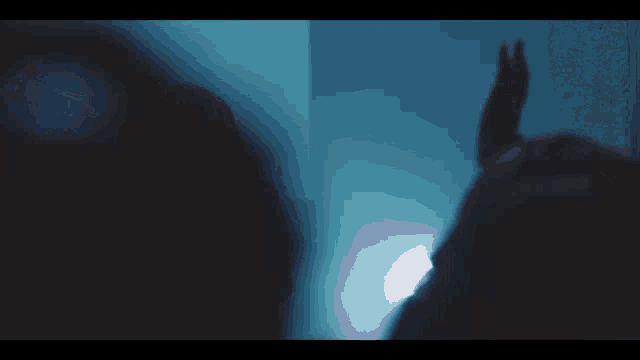 a man playing drums in a dark room