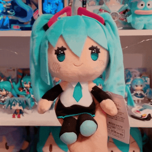 a stuffed hatsune miku doll sits on a table
