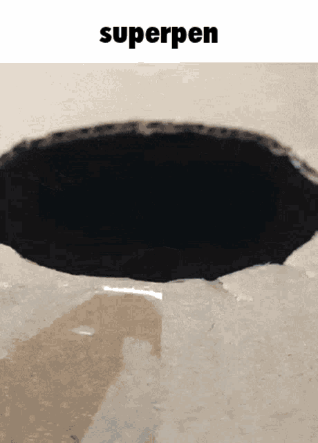 a hole in a wall with the word superpen below it
