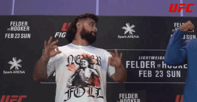 a man stands in front of a sign that says ufc