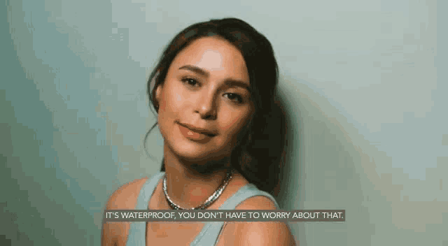 a woman wearing a necklace says it 's waterproof , you don 't have to worry about that