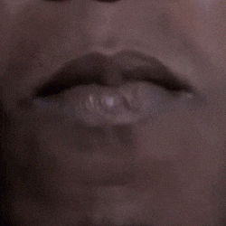 a close up of a man 's mouth with his tongue out