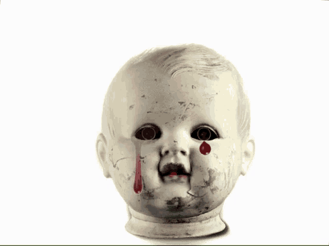 a baby doll with blood coming out of its eyes and mouth