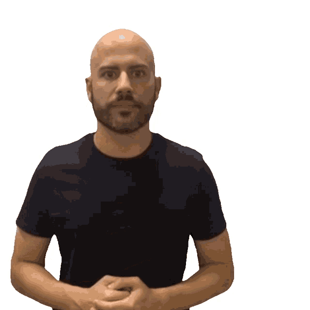 a bald man in a black shirt is holding his hands over his chest