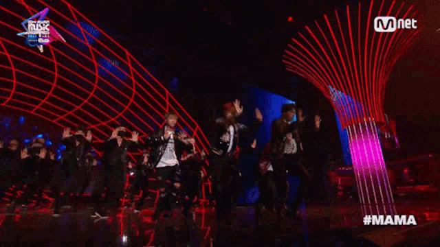 a group of people are dancing on a stage with the hashtag #mama