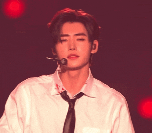 a man in a white shirt and tie with blood on his shirt