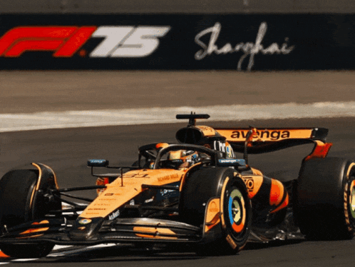 a yellow race car with avenga on the side is driving on a track