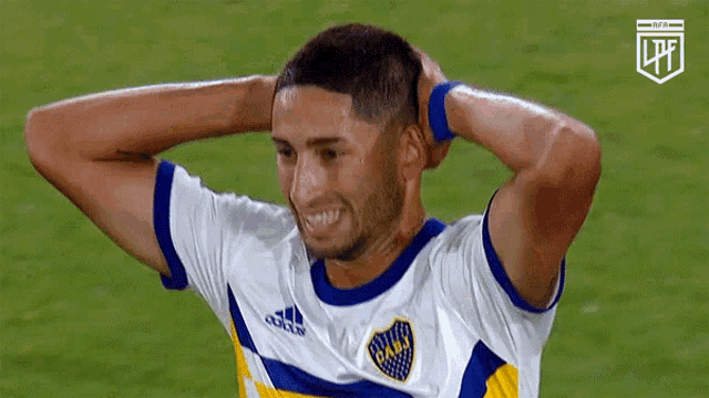 a soccer player wearing a blue and white jersey with the word cabj on it