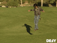 a person standing in a grassy field with the word defy on the bottom right