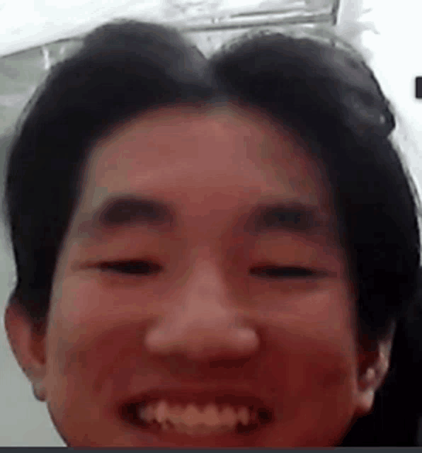 a close up of a person 's face with a smile on it .