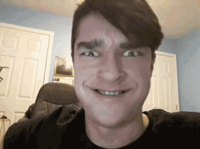 a young man making a funny face in front of a calendar