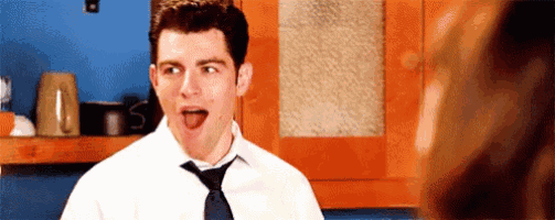 a man in a tie is sticking his tongue out .