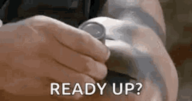 a person is holding a watch in their hand with the words `` ready up '' written next to it .