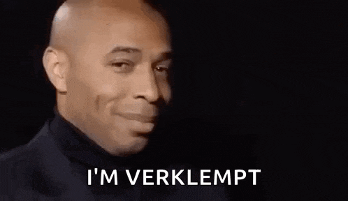 a man in a suit is smiling and saying `` i 'm verklept '' .