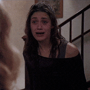 a woman in a black off the shoulder top is crying
