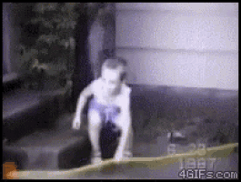 a young boy is jumping into a pool of water