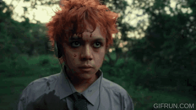 a man with red hair is running in the woods with a gif run.com watermark