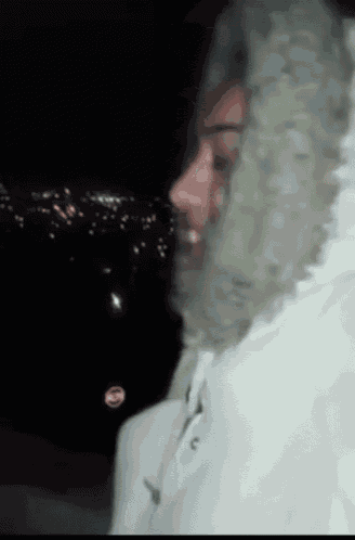 a person wearing a white jacket with a hood