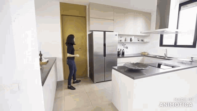 a woman is standing in a kitchen with the words made in animatica on the bottom