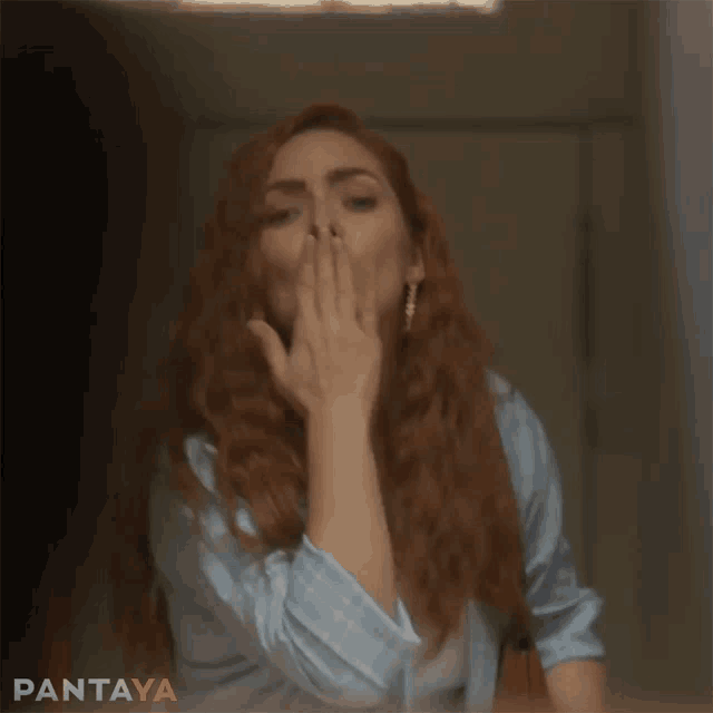 a woman with red hair is blowing a kiss with pantaya written in the corner